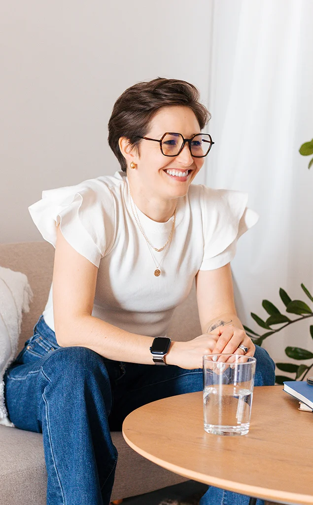 Pocket Nibbles | B2B SaaS Marketing Operations shows Chloe Pott, founder of Pocket Nibbles, smiling while seated at a table with a glass of water.